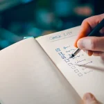 hand writing on a checklist in a notebook