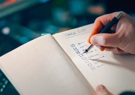 hand writing on a checklist in a notebook